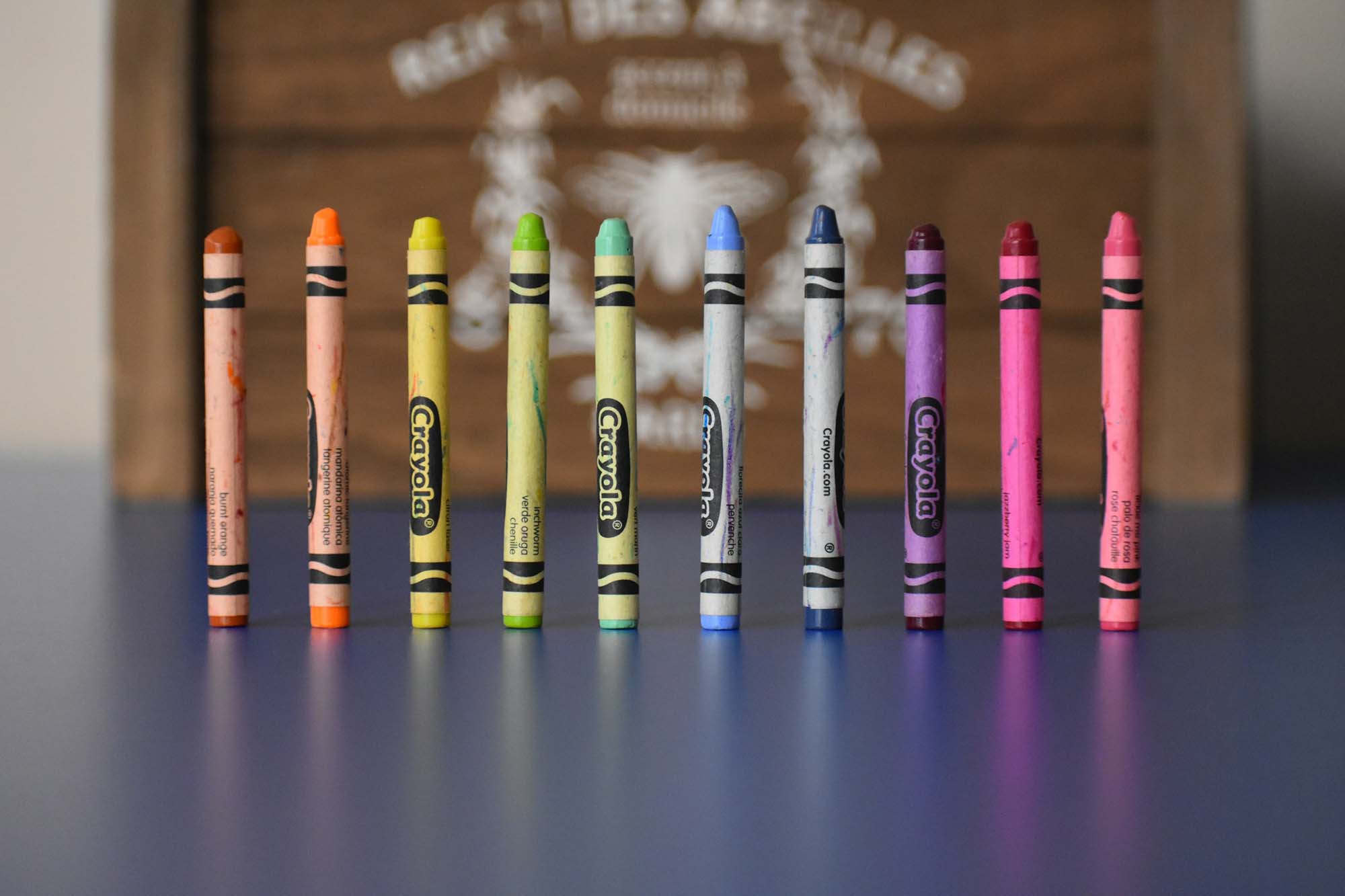 Several crayons in different colors stand in a row